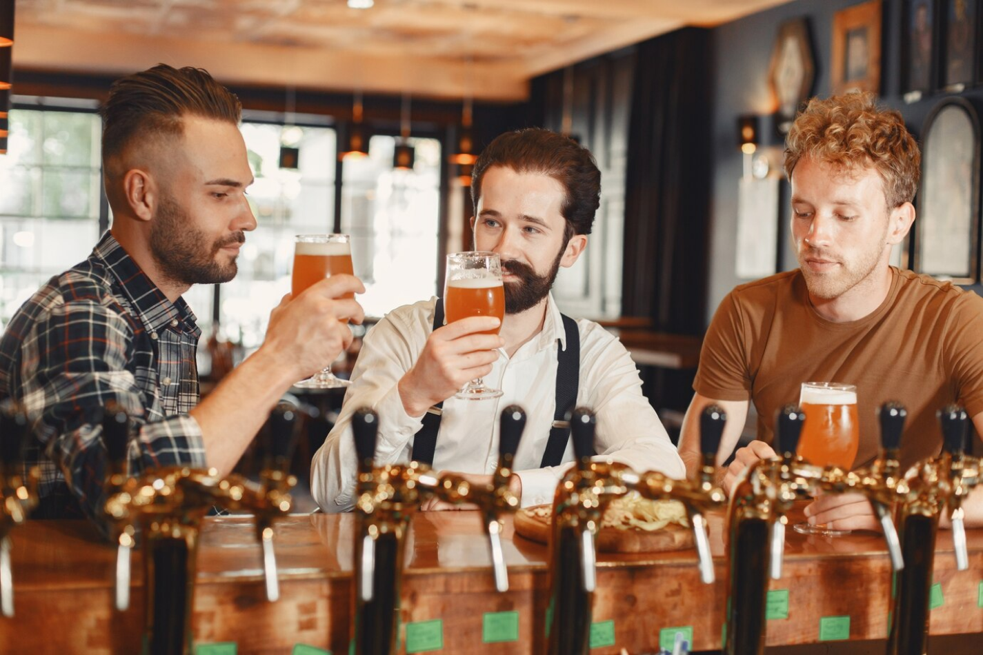 Guys drinking beer at the bar